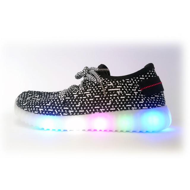 Children's black light-up sneakers with a button on the heel.