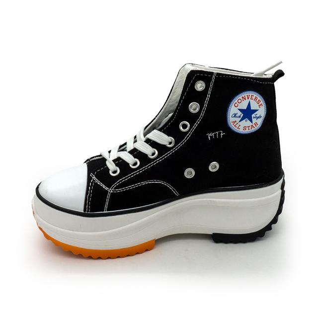 Converse sneakers on a black and white platform