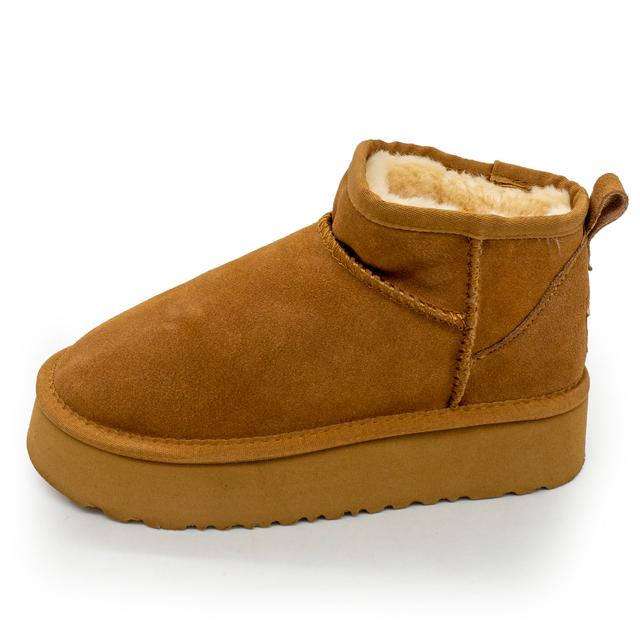 Low red Ugg boots on a high platform, natural suede